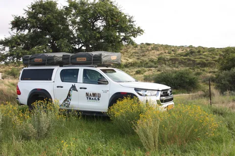 Namib Trails 4x4 Toyota Hilux with rooftop tents parked in the Namibian bush