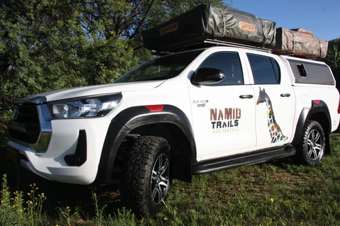 Close-up front view of Namib Trails 4x4 Toyota Hilux with off-road tyres and rooftop tents