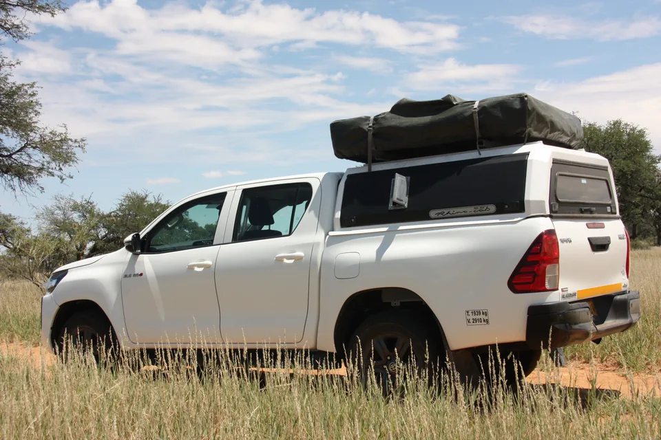 Rear view of Namib Trails 4x4 Toyota Hilux on savannah track