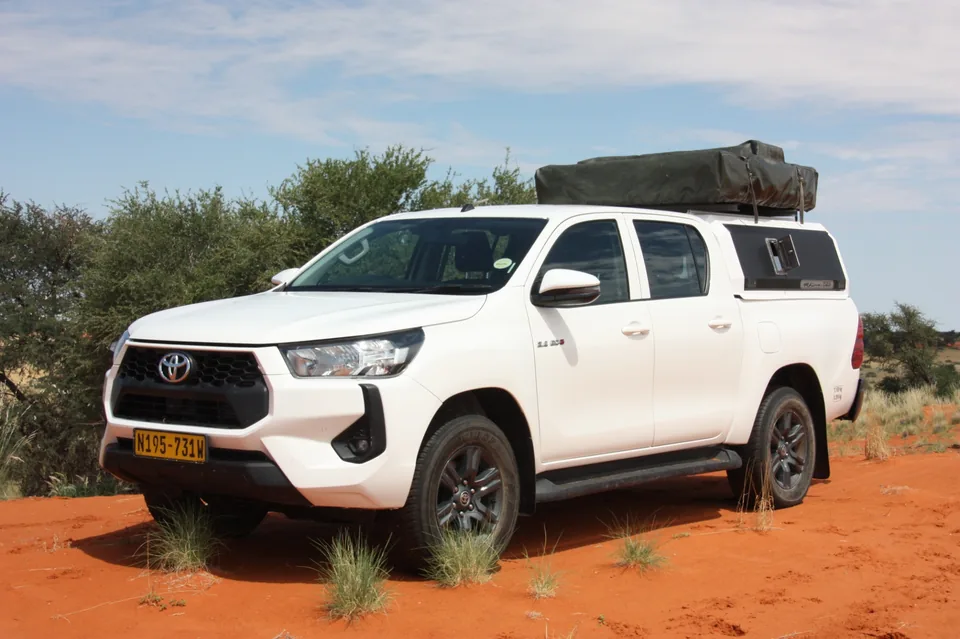 Namib Trails 4x4 Toyota Hilux on red sand dunes in Namibia