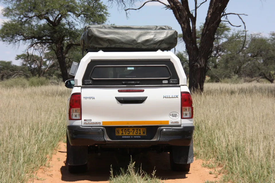 Side view of Namib Trails 4x4 Toyota Hilux in savannah grassland