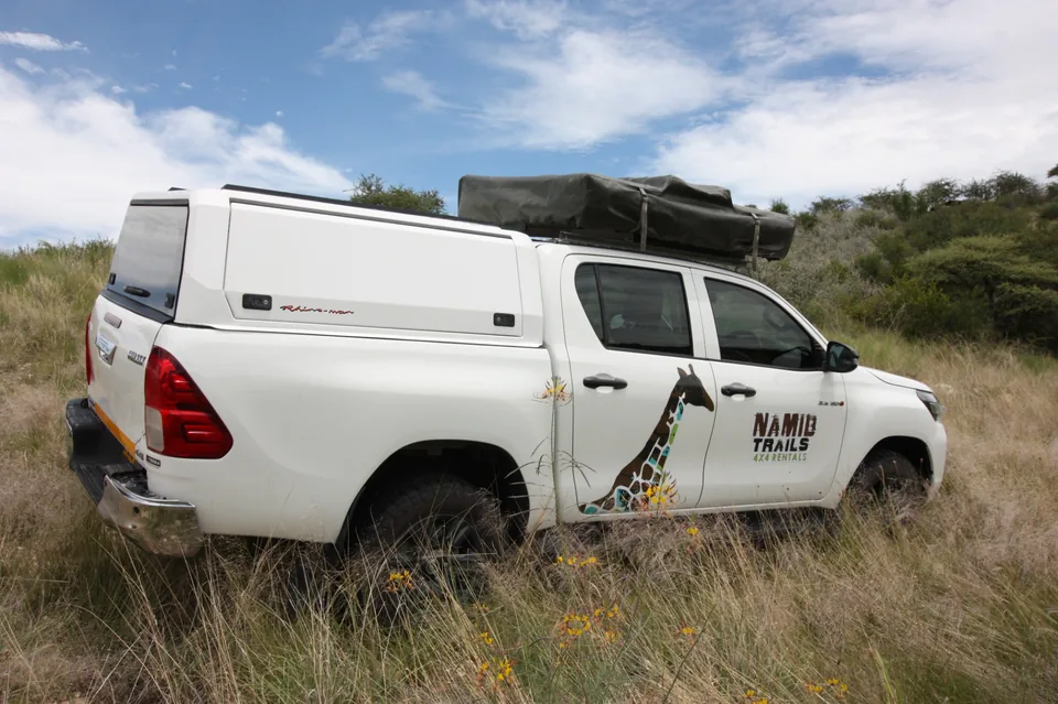 Namib Trails 4x4 Toyota Hilux at the Tropic of Capricorn sign